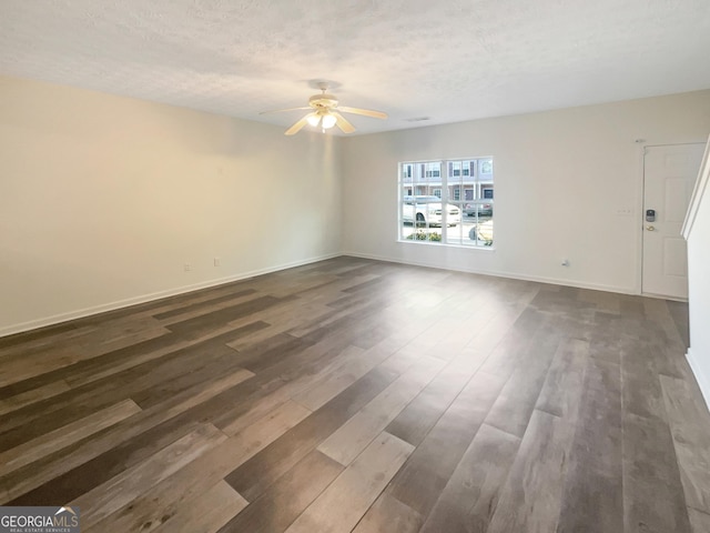 unfurnished room with a textured ceiling, ceiling fan, and dark hardwood / wood-style floors