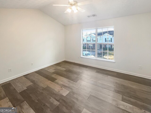 unfurnished room featuring dark hardwood / wood-style floors, ceiling fan, and vaulted ceiling