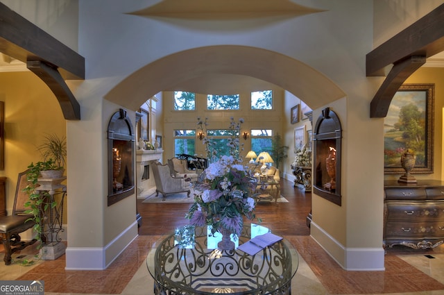 interior space with a towering ceiling and hardwood / wood-style flooring