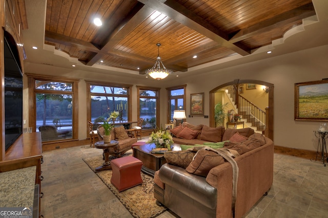 living room featuring coffered ceiling, wood ceiling, beam ceiling, and a chandelier