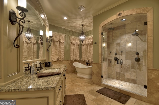 bathroom featuring vanity, ornamental molding, tile walls, and plus walk in shower