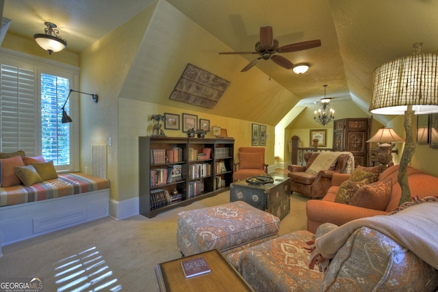 living room featuring ceiling fan with notable chandelier, lofted ceiling, and carpet floors