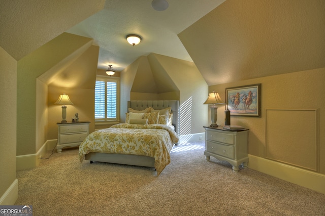 bedroom featuring a textured ceiling, carpet, and lofted ceiling