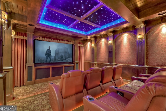 cinema room with carpet, coffered ceiling, and decorative columns