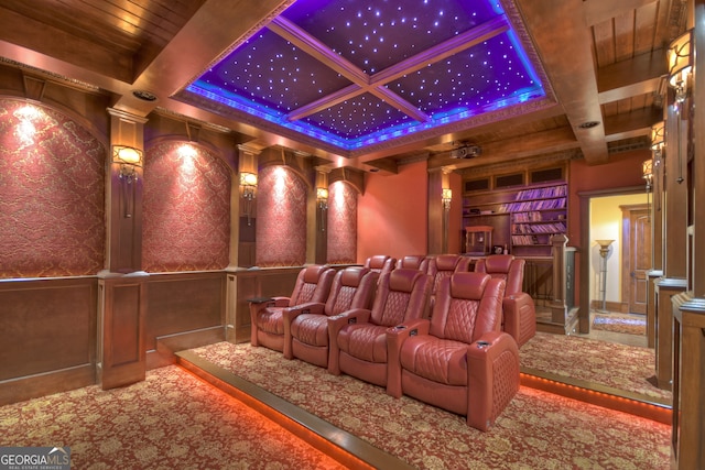 cinema room with coffered ceiling, beam ceiling, and ornate columns