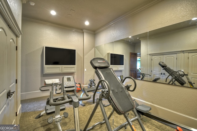 exercise room featuring carpet and ornamental molding