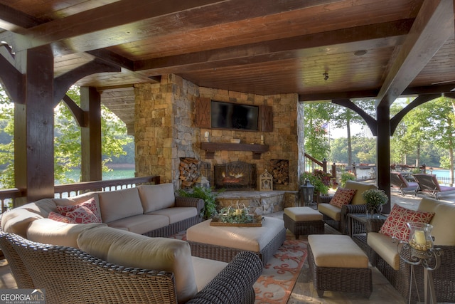 view of patio featuring an outdoor living space with a fireplace