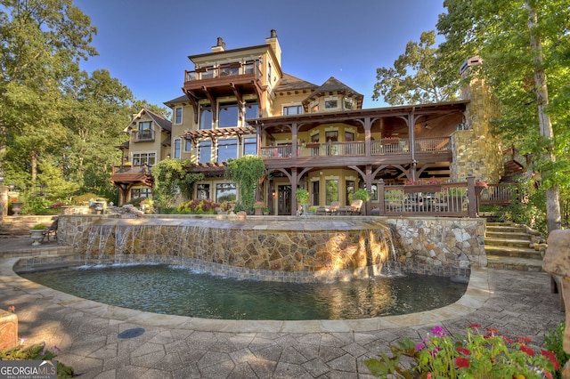 exterior space with pool water feature