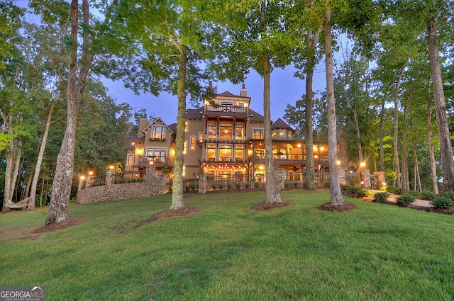 rear view of house with a lawn