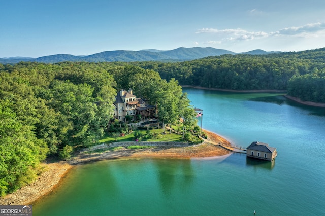 birds eye view of property with a water and mountain view