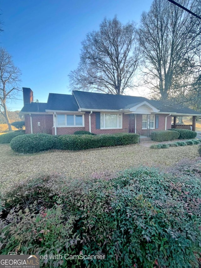 ranch-style home featuring brick siding