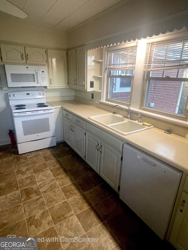 kitchen with sink, tile patterned flooring, and white appliances