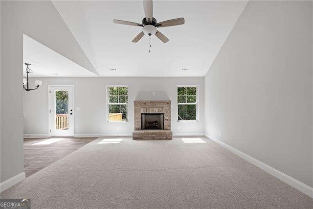 unfurnished living room with light carpet, high vaulted ceiling, and ceiling fan