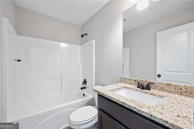 full bathroom featuring vanity, bathtub / shower combination, and toilet