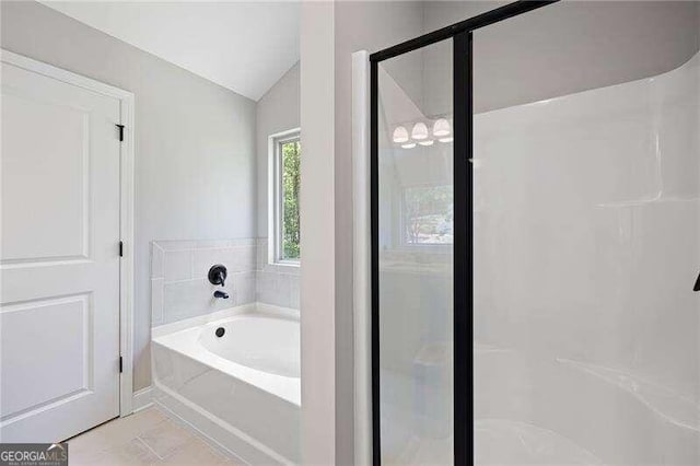 bathroom with lofted ceiling, plus walk in shower, and tile patterned flooring