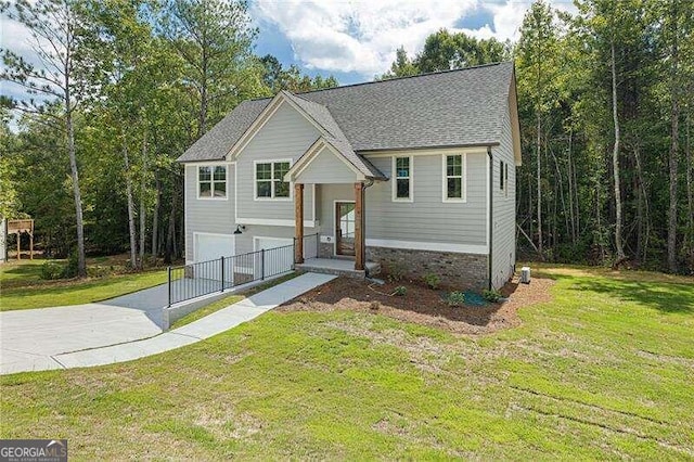 raised ranch with a garage and a front lawn