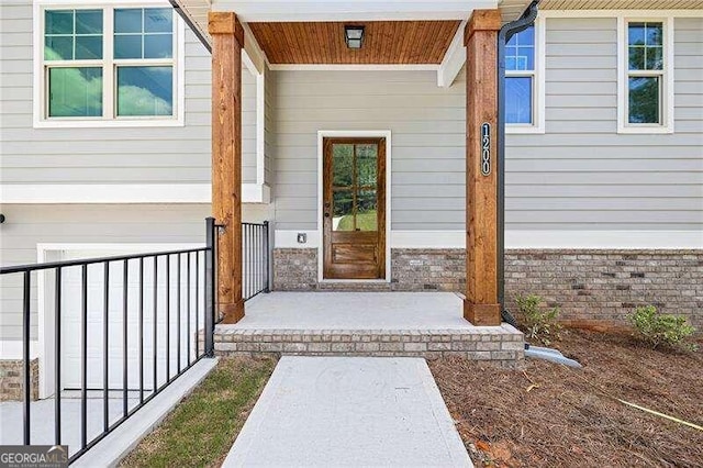 view of exterior entry with a porch