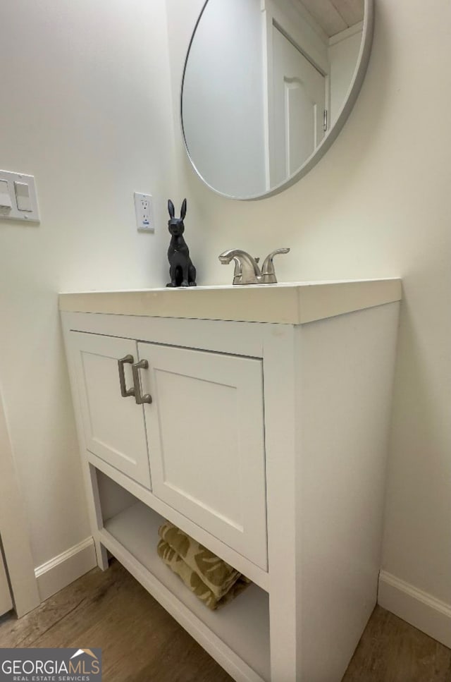 bathroom with hardwood / wood-style floors and vanity