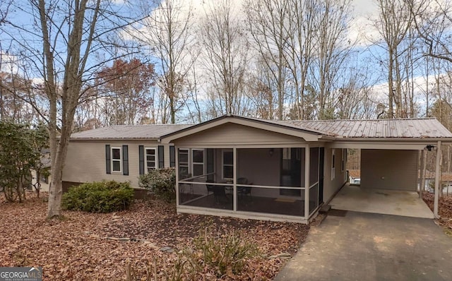 rear view of property with a carport