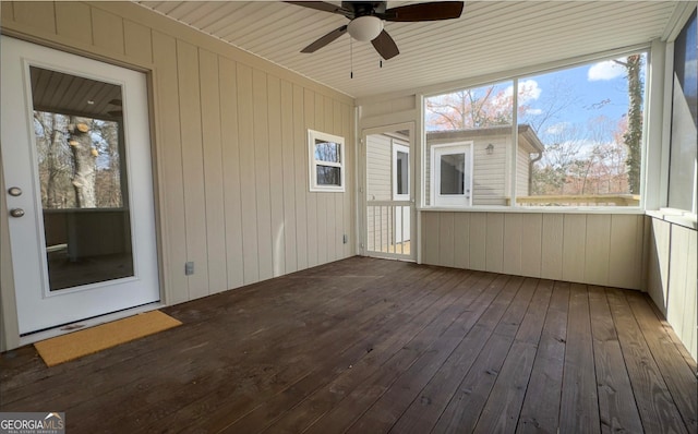 unfurnished sunroom with ceiling fan