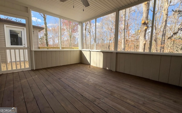 unfurnished sunroom featuring ceiling fan