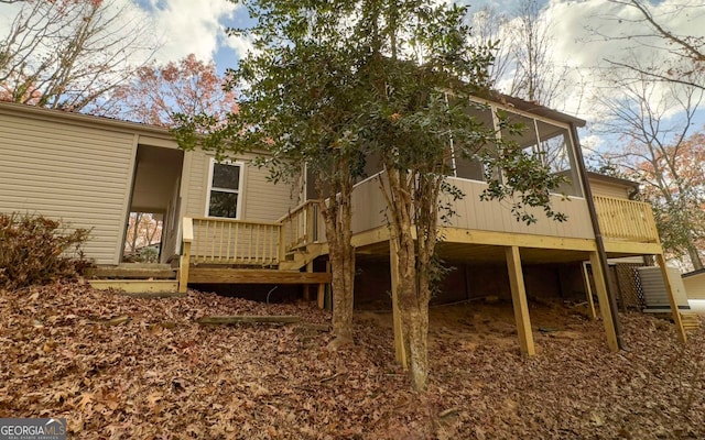 rear view of house featuring a deck