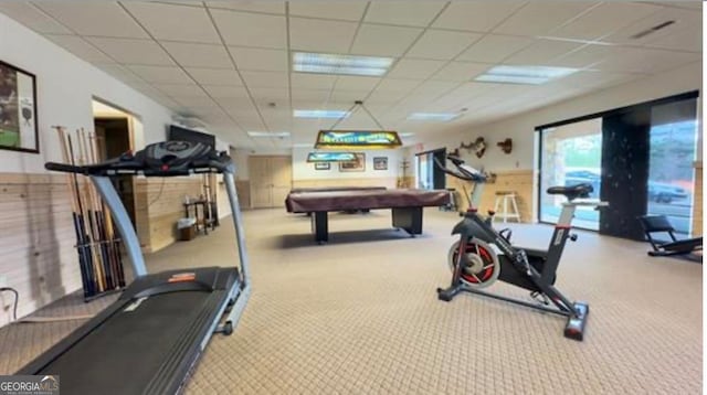 exercise room with a paneled ceiling, light colored carpet, and billiards