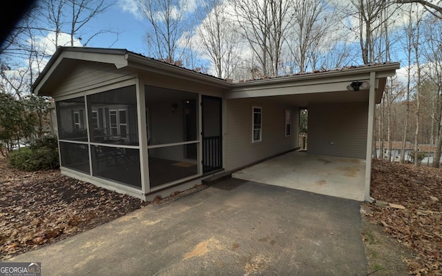 back of property with a carport