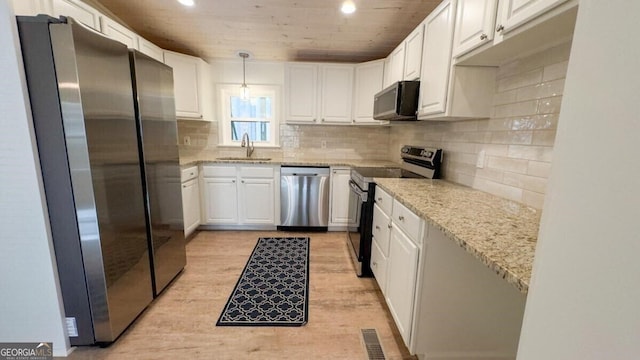 kitchen with white cabinetry, sink, light wood-type flooring, and stainless steel appliances