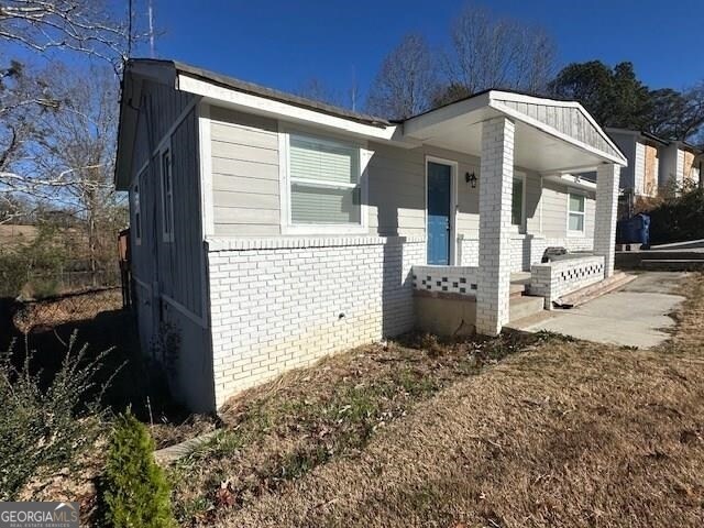 view of side of property featuring a porch