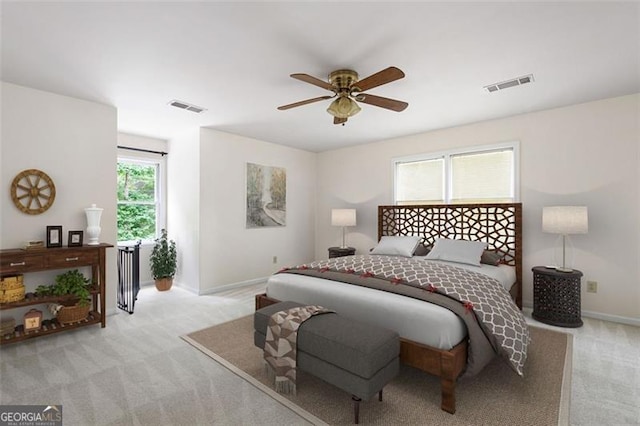 bedroom featuring light carpet and ceiling fan