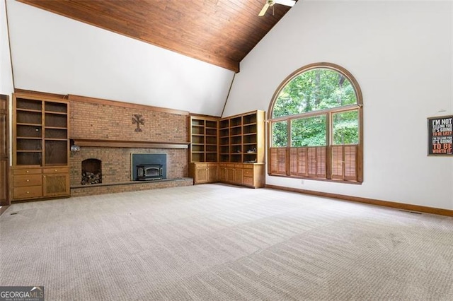 unfurnished living room with carpet flooring, ceiling fan, high vaulted ceiling, wooden ceiling, and a fireplace