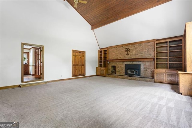 unfurnished living room with light carpet, high vaulted ceiling, wood ceiling, and ceiling fan