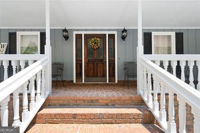 view of exterior entry with covered porch