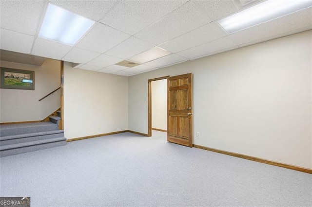 basement with a drop ceiling and carpet floors