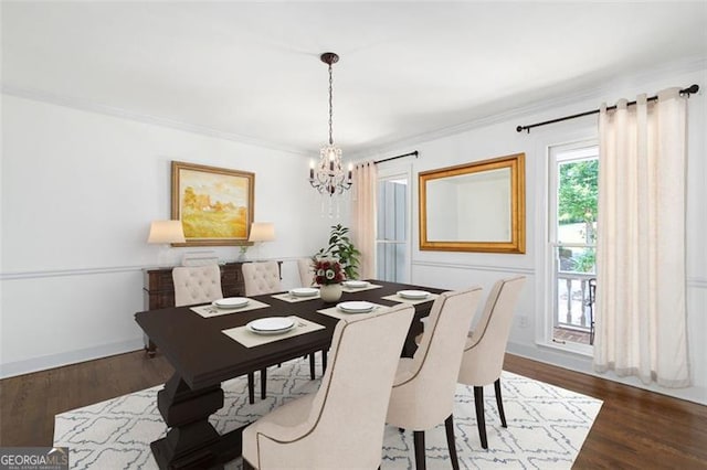 dining area with crown molding, dark hardwood / wood-style flooring, and a notable chandelier