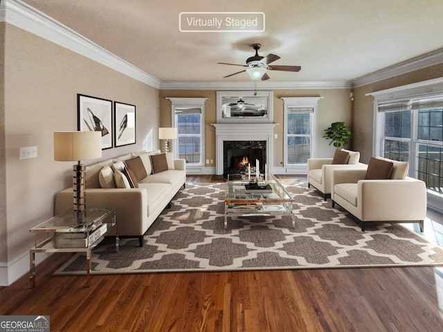 living room with ceiling fan, a fireplace, crown molding, and wood-type flooring