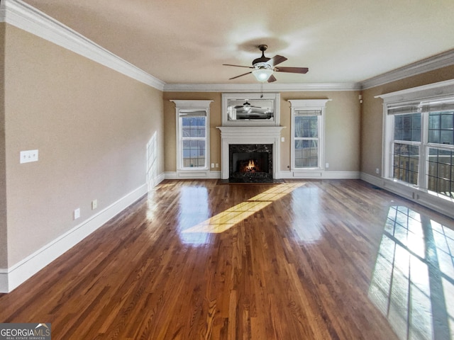 unfurnished living room with a fireplace, dark hardwood / wood-style flooring, ceiling fan, and ornamental molding