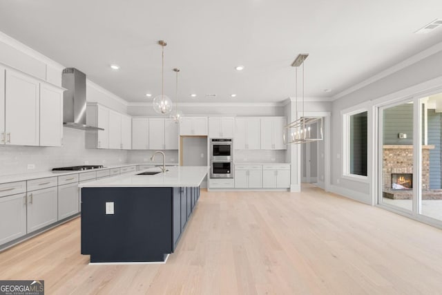 170 Ewing Way, Dacula, GA 30019 - kitchen with wall chimney exhaust hood, a chandelier, gas cooktop, ornamental molding, and light countertops