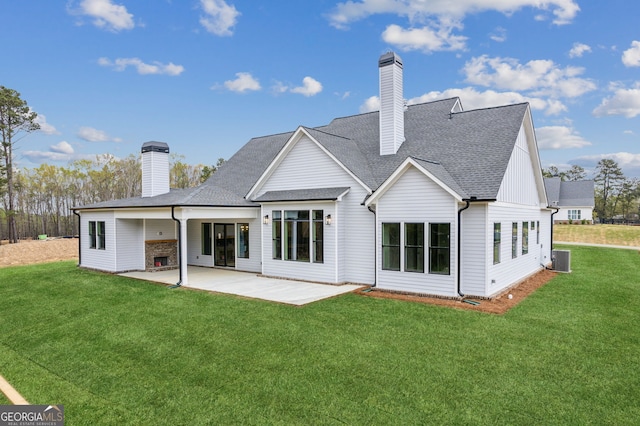 170 Ewing Way, Dacula, GA 30019 - rear view of house with a chimney, a patio, and a lawn