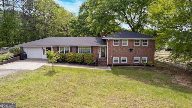 split level home featuring a garage and a front lawn