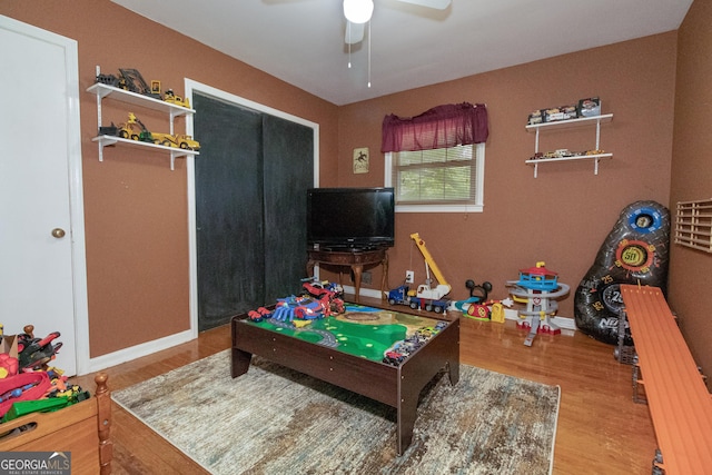 recreation room featuring hardwood / wood-style floors and ceiling fan