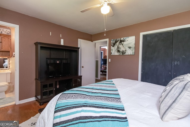 bedroom with ensuite bath, ceiling fan, and hardwood / wood-style floors