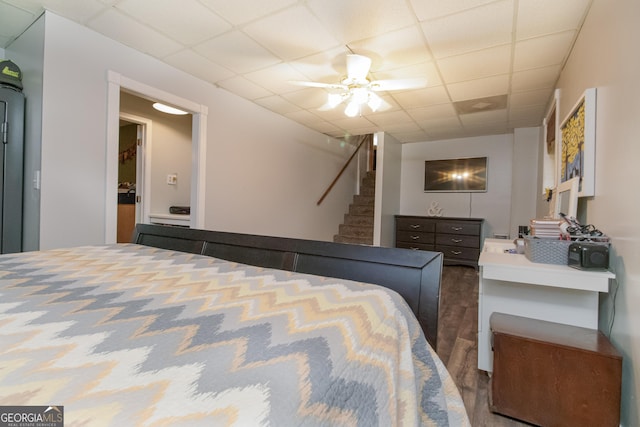 bedroom with a paneled ceiling and ceiling fan