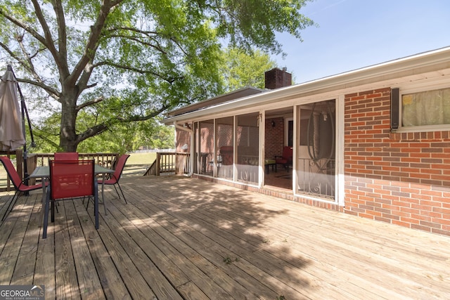 wooden terrace featuring a sunroom