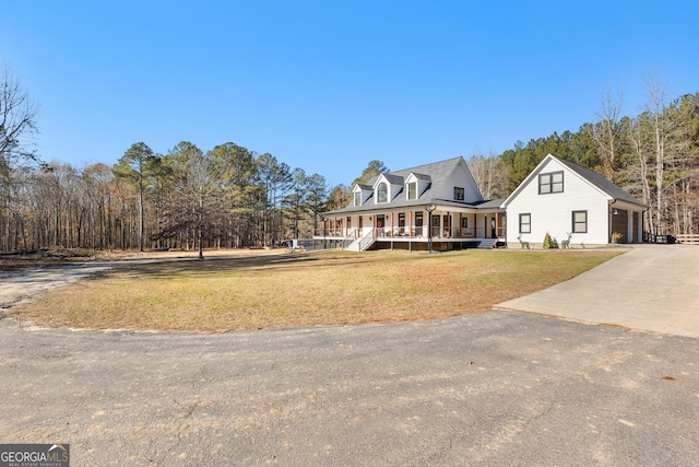 cape cod home with a porch, a garage, and a front lawn