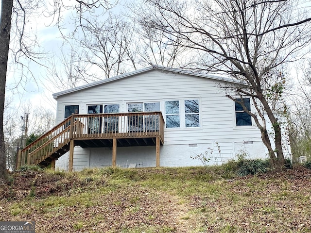 rear view of house with a wooden deck