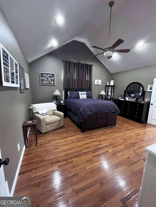 bedroom featuring wood-type flooring, ceiling fan, and lofted ceiling