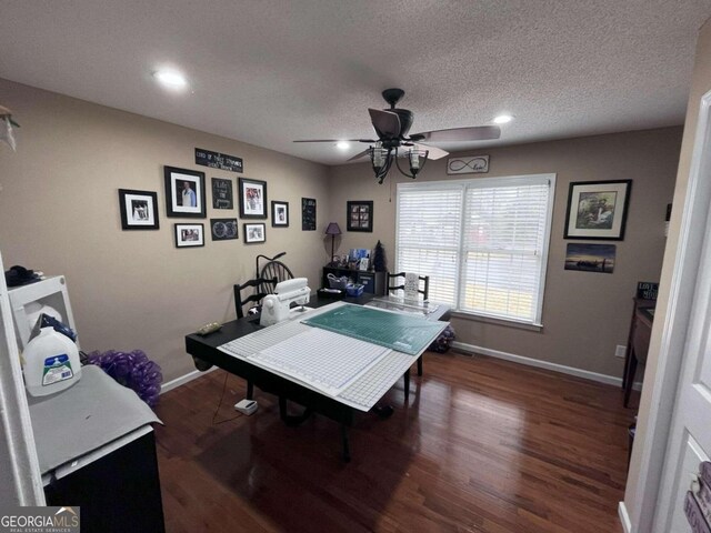 rec room with dark hardwood / wood-style flooring, a textured ceiling, and ceiling fan