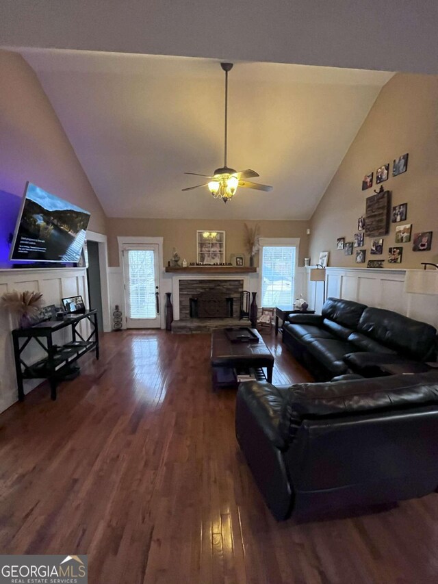 living room featuring ceiling fan, dark hardwood / wood-style flooring, and high vaulted ceiling